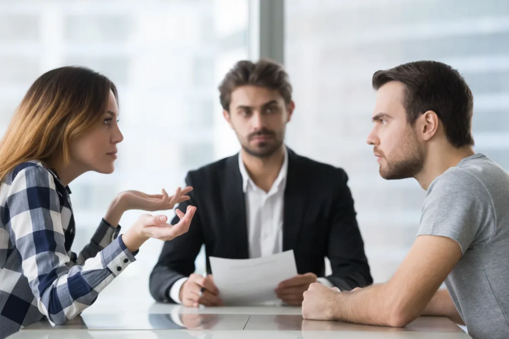 A family law attorney mediating a couple in their office