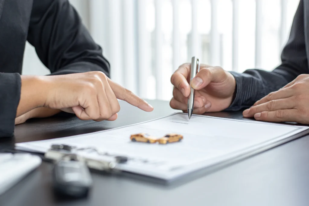 A lawyer for a car accident helping a client sign papers