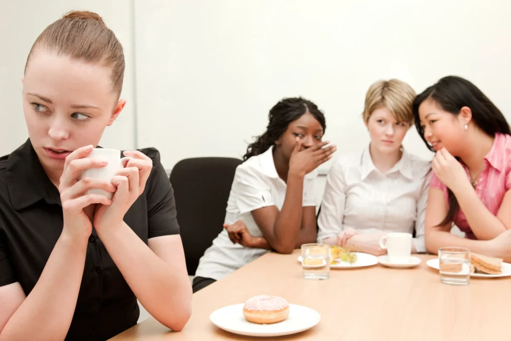 A woman facing unfair treatment at work from coworkers