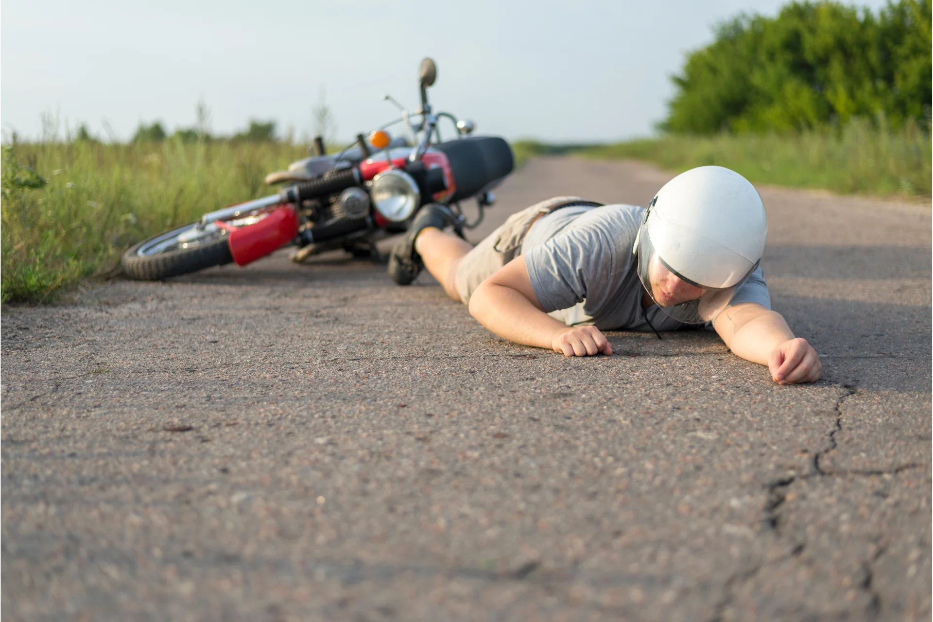 Man lying on the road because of a motorcycle crash