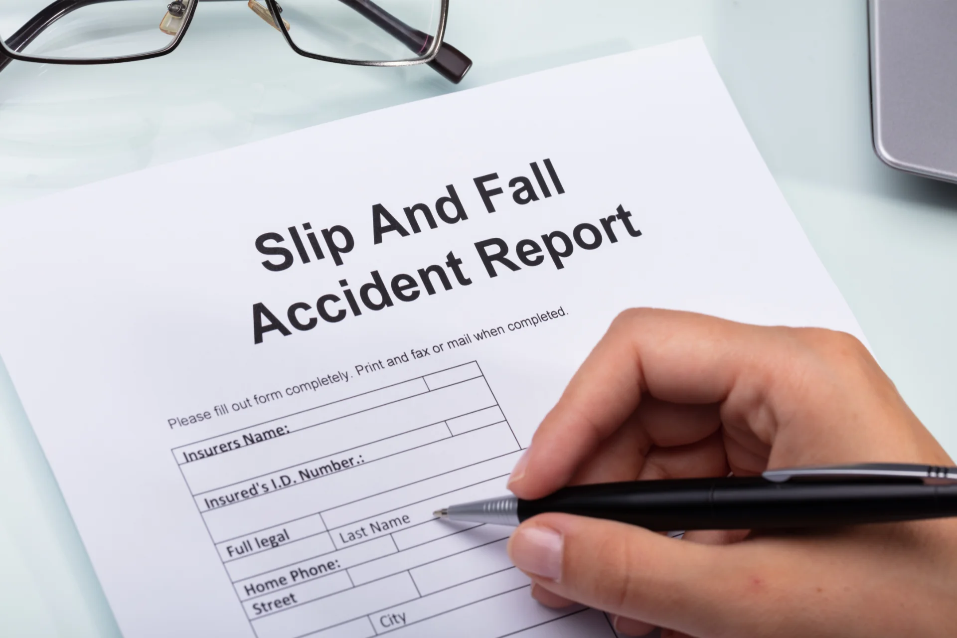Man filling out a slip and fall report for a lawyer